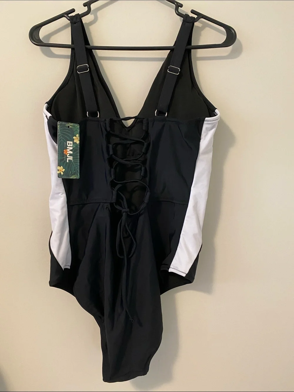 Black One-Piece Swimsuit with White Side Panels and surprising back detail.